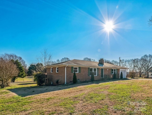 single story home with a garage and a front yard