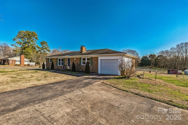 single story home with a garage and a front yard