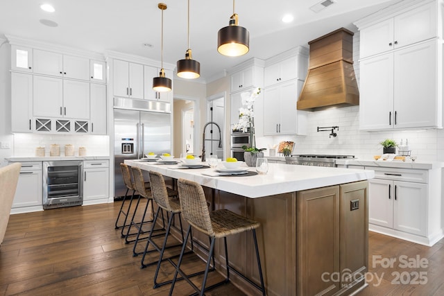 kitchen featuring wine cooler, white cabinets, and custom exhaust hood