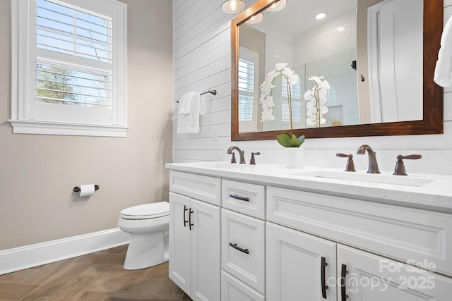 bathroom featuring vanity, toilet, and a shower with door