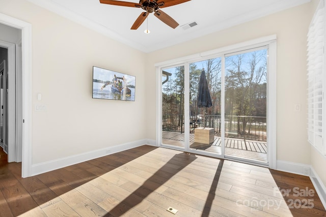 interior space with ceiling fan, dark hardwood / wood-style flooring, and crown molding