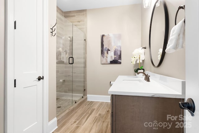 bathroom with a shower with door and vanity