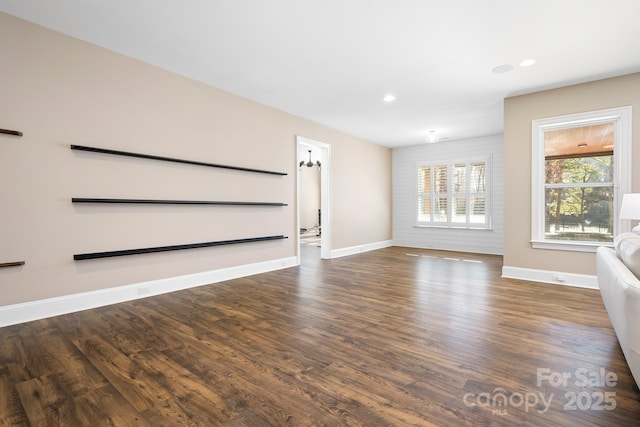 unfurnished living room with dark hardwood / wood-style flooring