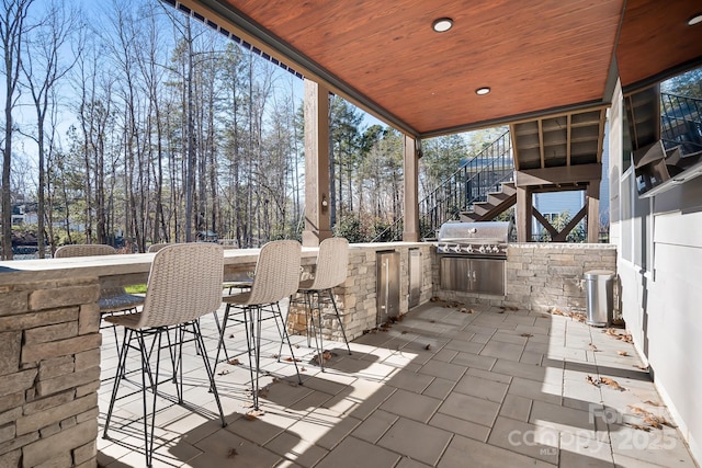 view of patio / terrace with area for grilling, exterior bar, and exterior kitchen