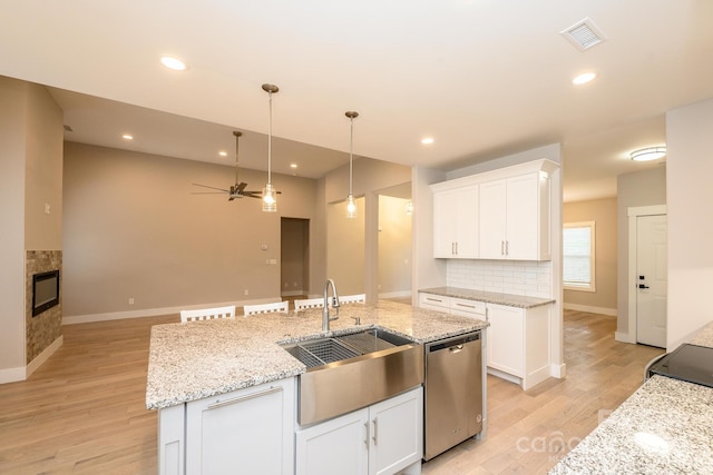 kitchen featuring sink, white cabinets, and stainless steel dishwasher