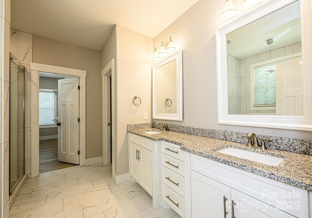 bathroom with vanity and a shower with shower door