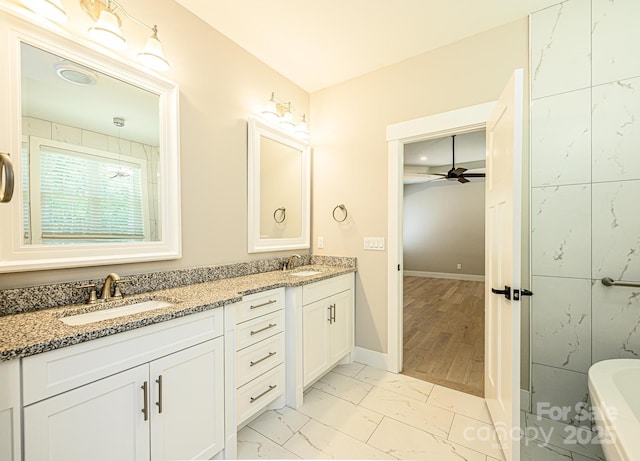 bathroom featuring ceiling fan and vanity