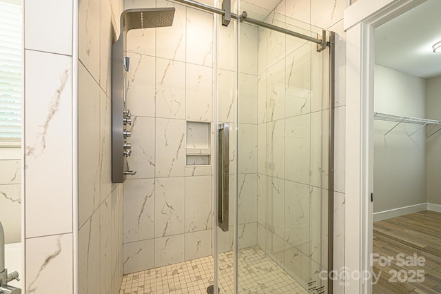 bathroom with hardwood / wood-style floors and a shower with door