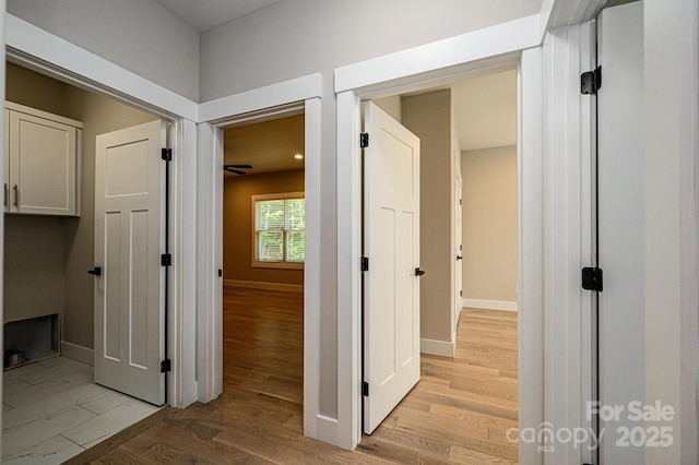 hallway with light hardwood / wood-style flooring