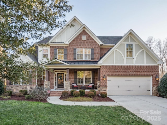 view of front of home with a porch, a garage, and a front yard