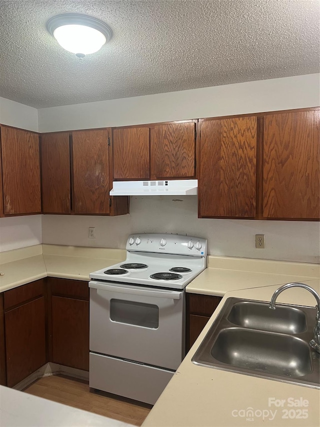 kitchen featuring sink, a textured ceiling, and white range with electric cooktop