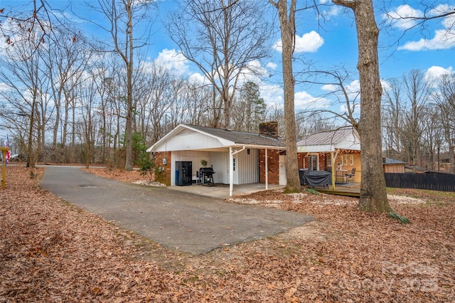 view of side of property featuring a carport