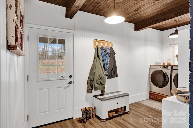 laundry room with wood-type flooring, washing machine and dryer, and wood ceiling