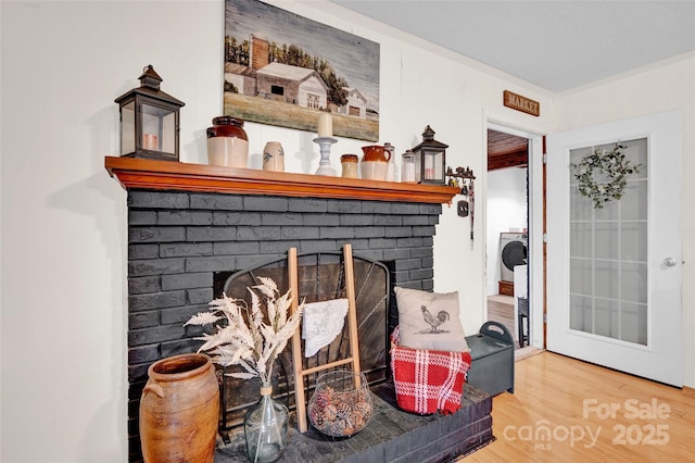 room details featuring hardwood / wood-style floors and a brick fireplace