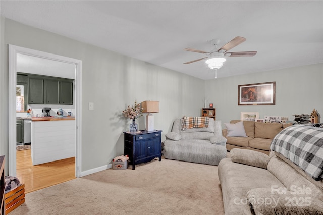 living room with light colored carpet and ceiling fan