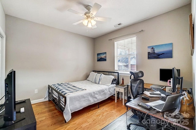 bedroom with ceiling fan and wood-type flooring