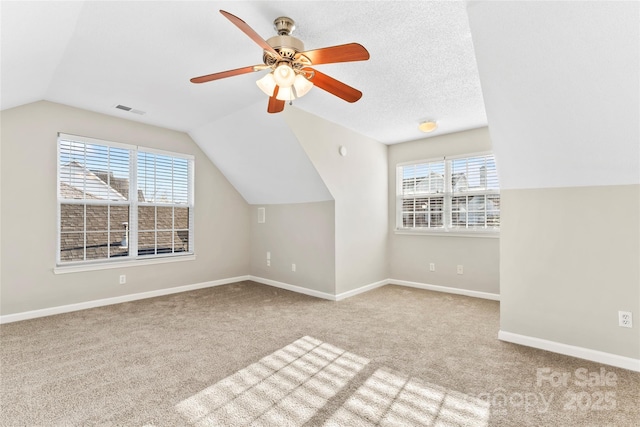 bonus room featuring a wealth of natural light, ceiling fan, light colored carpet, and vaulted ceiling