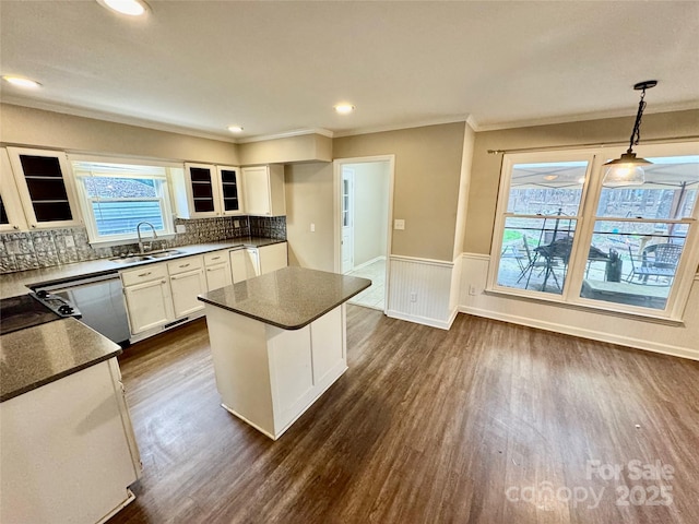 kitchen featuring white cabinetry, dishwasher, sink, dark hardwood / wood-style flooring, and pendant lighting