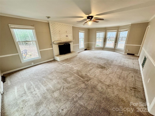 unfurnished living room with ceiling fan, a fireplace, carpet, and ornamental molding