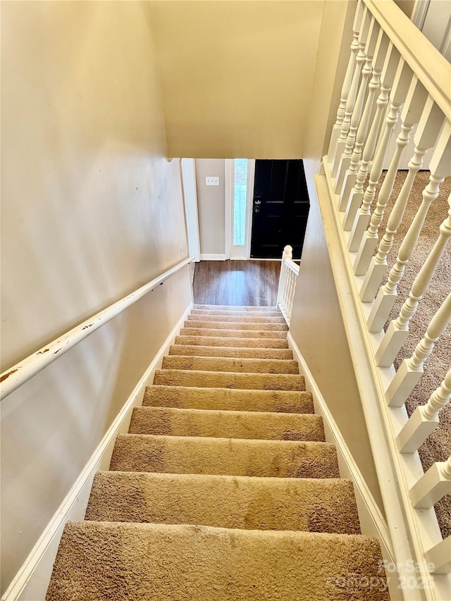 stairs with wood-type flooring