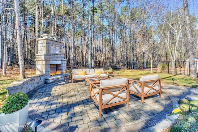 view of patio / terrace with an outdoor living space with a fireplace