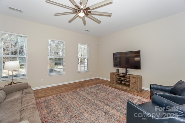 living room with ceiling fan and wood-type flooring