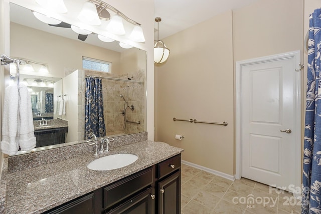 bathroom featuring vanity and a shower with shower curtain