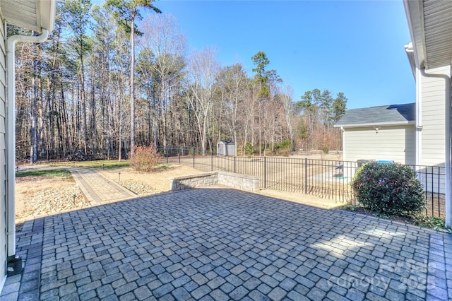 view of patio with a storage unit