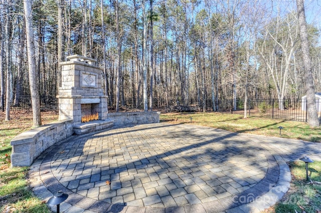 view of patio / terrace with an outdoor stone fireplace