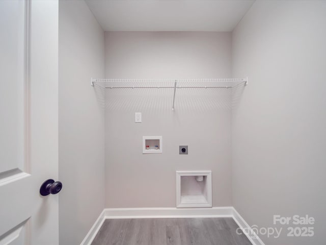 laundry room with hookup for an electric dryer, laundry area, washer hookup, wood finished floors, and baseboards