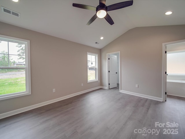 unfurnished bedroom with recessed lighting, visible vents, vaulted ceiling, wood finished floors, and baseboards