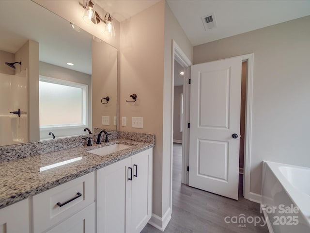 full bathroom featuring visible vents, a shower, a bathing tub, wood finished floors, and vanity