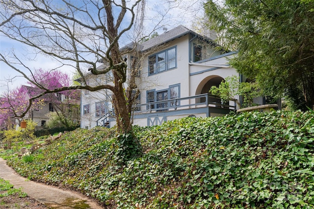 back of property featuring a balcony