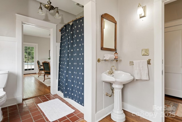 bathroom with tile patterned flooring, toilet, and walk in shower