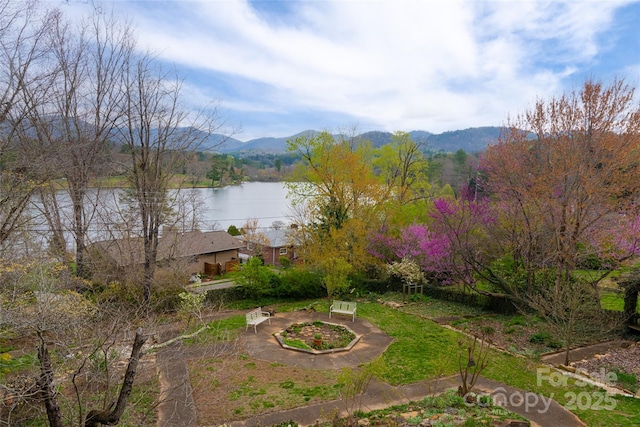 exterior space with a water and mountain view