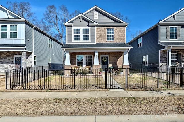 craftsman-style home with a porch and a front lawn