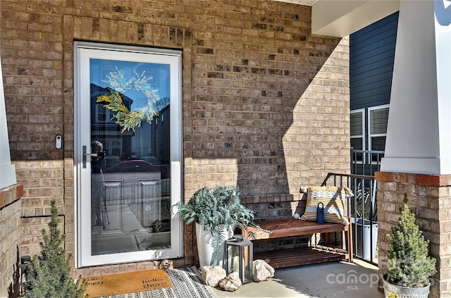 view of exterior entry with a porch