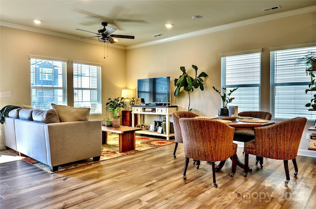 interior space featuring hardwood / wood-style flooring, ceiling fan, and crown molding