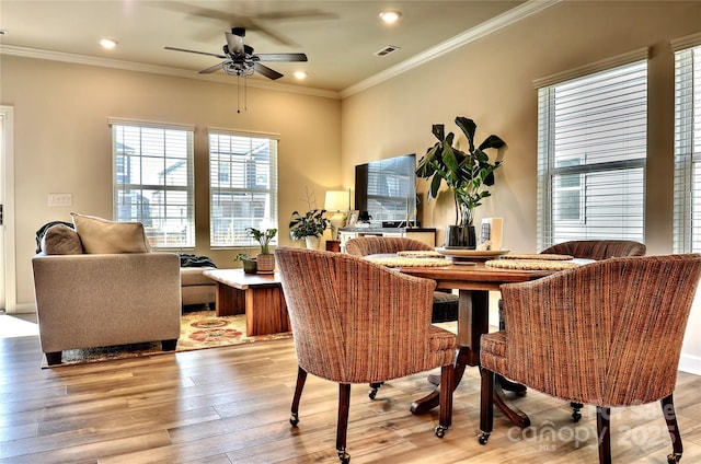 dining room featuring ceiling fan, light hardwood / wood-style flooring, and crown molding