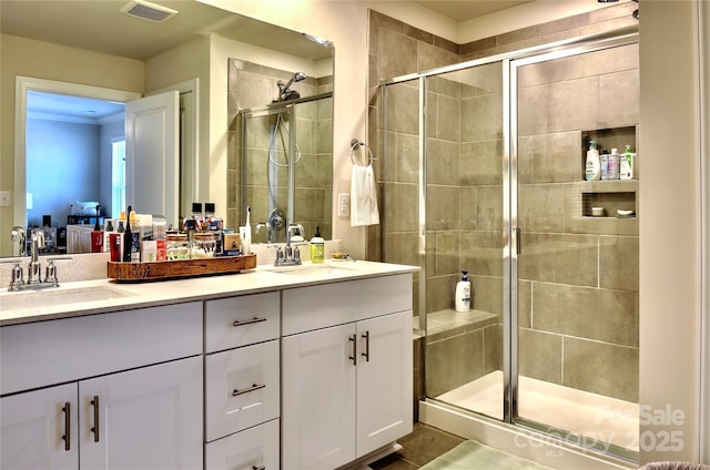 bathroom with vanity and a shower with shower door