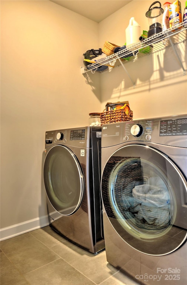 laundry area with tile patterned floors and separate washer and dryer