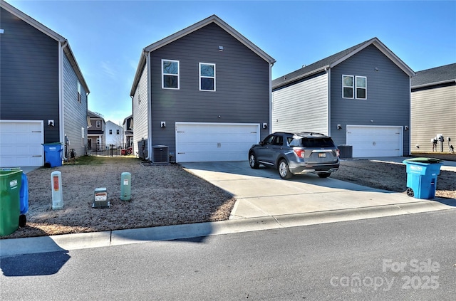 front of property with a garage and cooling unit