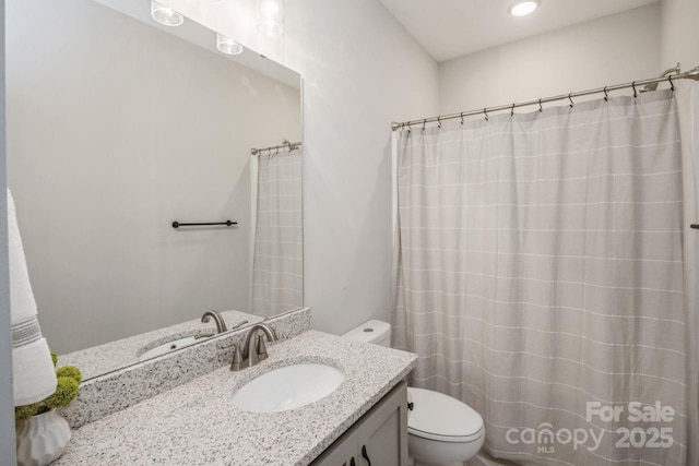 bathroom with toilet and vanity