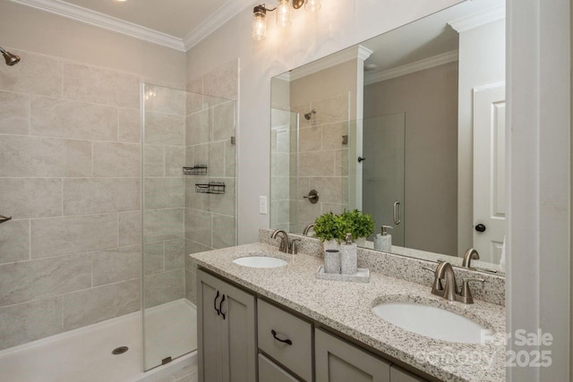 bathroom featuring a shower with door, ornamental molding, and vanity