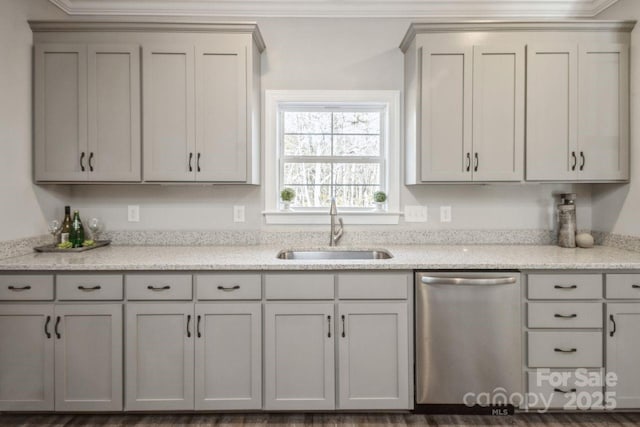 kitchen featuring light stone countertops, dishwasher, sink, gray cabinetry, and crown molding