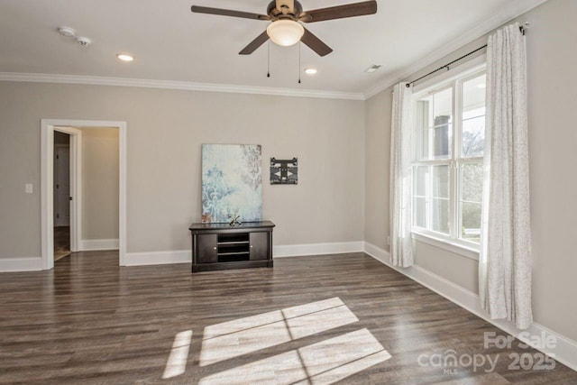 spare room featuring ceiling fan, dark hardwood / wood-style flooring, a wealth of natural light, and ornamental molding