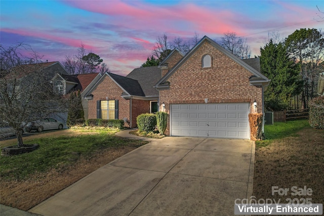 view of property with a garage, cooling unit, and a lawn