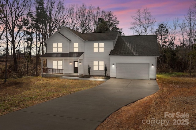 view of front of home with covered porch and a garage