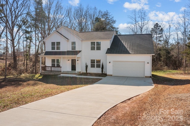 view of front of property with a garage, a front lawn, and covered porch