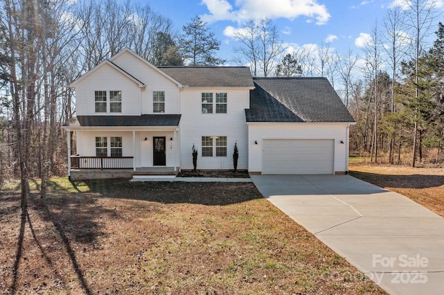 view of property featuring a garage and a porch